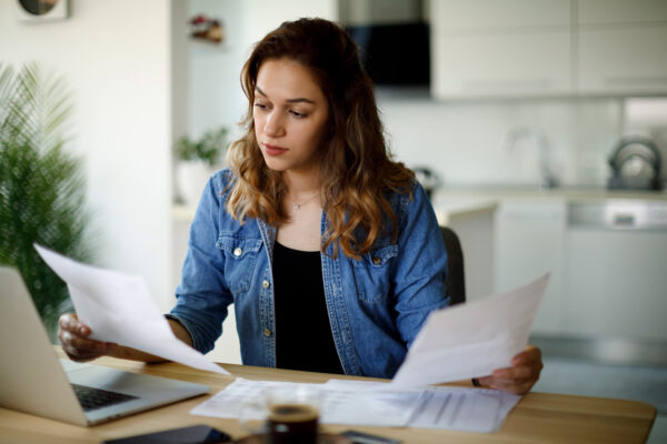 woman looking at financial papers